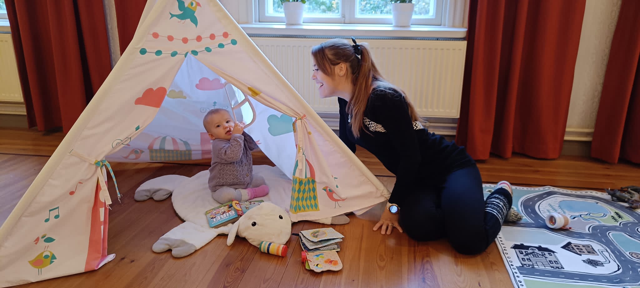 Familjeträff på Domprostgården Mamma med barn på golvet.