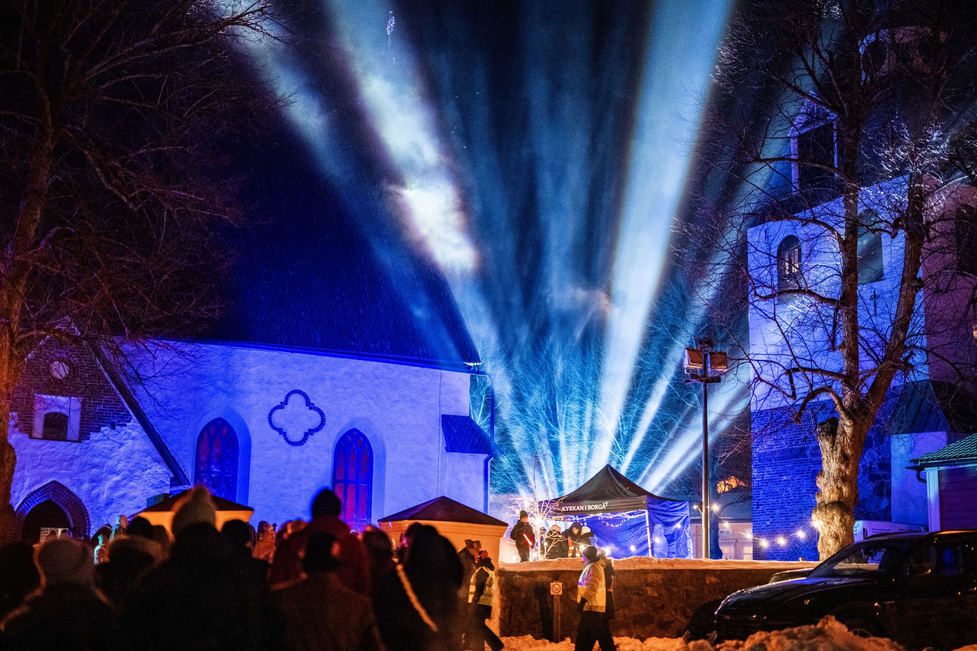Upplyst domkyrka, människor på väg till kyrkan